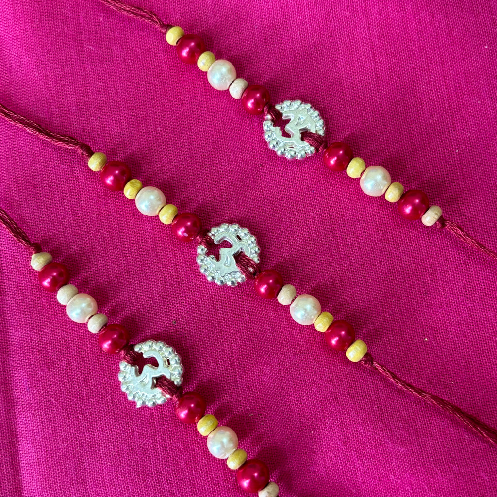 Rakhi- ohm silver pendent and beads(set of 3)